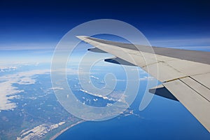 Airplane flying over ocean and island