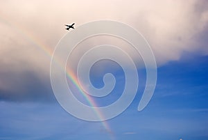 Airplane flying over rainbow