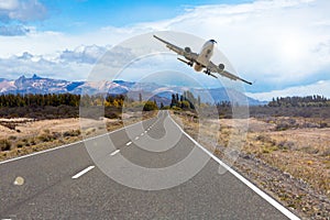 Airplane flying over roadway