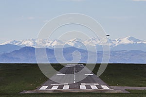 Airplane flying over a runway