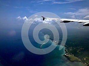 Airplane Flying over Shore in Jamaica