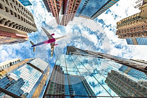 Airplane flying over skyscrapers