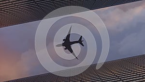 Airplane flying over the top big city skyscraper office buildings. 3d rendering