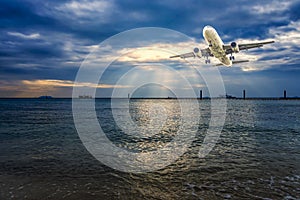 Airplane flying over tropical sea