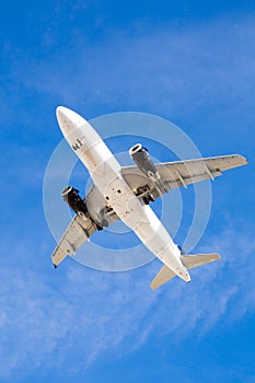 Airplane Flying Overhead with Blue Sky