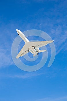 Airplane Flying Overhead with Blue Sky