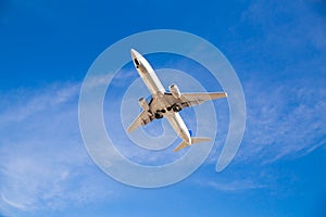 Airplane Flying Overhead with Blue Sky