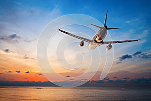 Airplane flying at sunset