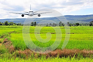 Airplane frying over the green rice flied Mountain background photo