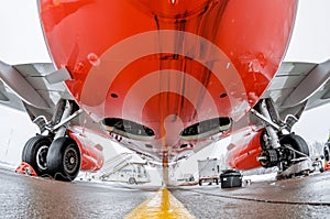 Airplane fuselage and main landing gear repair, bottom view close up.