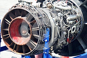 Airplane gas turbine engine detail in aviation hangar.