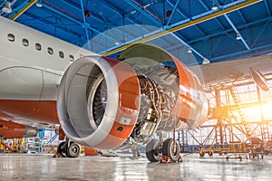 Airplane in the hangar, the engine under repair close-up