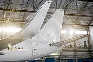 Airplane in the hangar, view of the wings and tail.