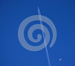 Airplane, intense blue sky and moon