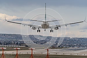 Airplane Jetliner arriving at airport runway photo