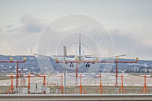 Airplane Jetliner arriving at airport runway photo