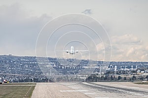 Airplane Jetliner departing at airport runway photo