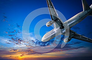 Airplane journey and sunset sky. Air traveling background