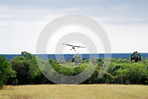 Airplane land in grass airfield