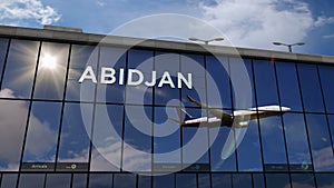 Airplane landing at Abidjan Ivory Coast airport mirrored in terminal