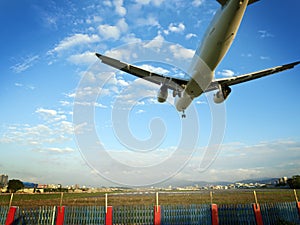 Airplane landing at airport against blue sky,Taipei,Taiwan