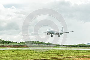 Airplane is landing on the airport before a storm approaching