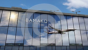 Airplane landing at Bamako Mali airport mirrored in terminal