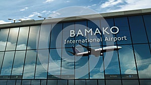 Airplane landing at Bamako Mali airport mirrored in terminal
