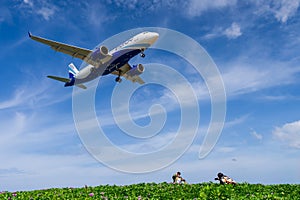 airplane landing with blue sky background at Phuket airport, Thailand