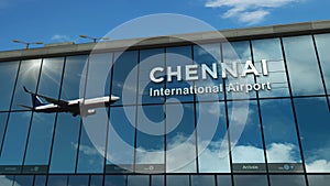 Airplane landing at Chennai India airport mirrored in terminal