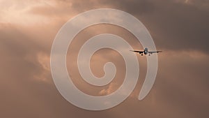 Airplane landing in cloudy sky