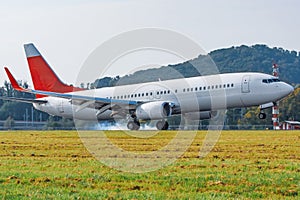 Airplane landing on runway side view touchdown with tire smoke