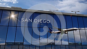 Airplane landing at San Diego California, USA airport mirrored in terminal