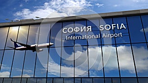 Airplane landing at Sofia mirrored in terminal
