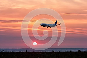 Airplane landing at sunrise