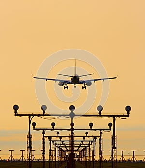 Airplane landing in sunset