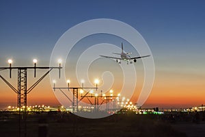 Airplane landing at sunset photo