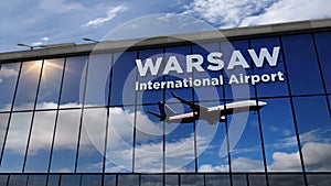 Airplane landing at Warsaw Poland mirrored in terminal