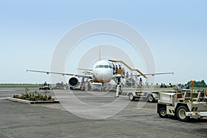 Airplane loading passengers and luggage.