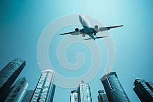Airplane with modern buildings skyline