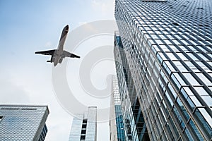 Airplane and modern office building photo