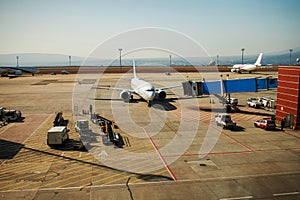 Airplane near the terminal ready to take off - Modern international airport.