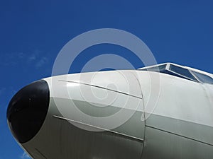 Airplane nose in blue sky