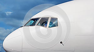 Airplane nose cockpit closup shot in blue sky background