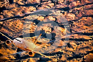Airplane over desert during sunset in Middle East