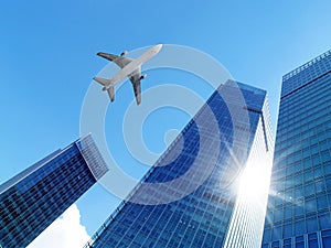Airplane over office buildings.