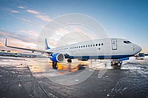 Airplane parked at the airport at the sun dawn sky