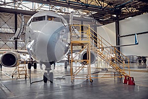 Airplane at parking apron in the aviation hangar