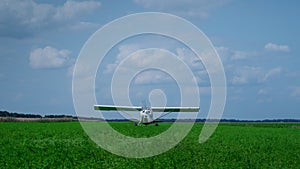 Airplane parking green field. Small private plane landing after flight on grass.