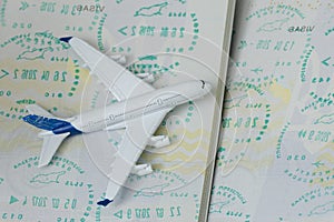 Airplane on passport pages with a visa. Close up